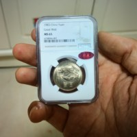 1983年长城币一元NGC评级MS65红标背逆15度